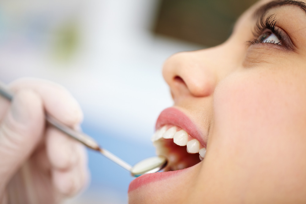 Woman having an oral health examination by a dentist